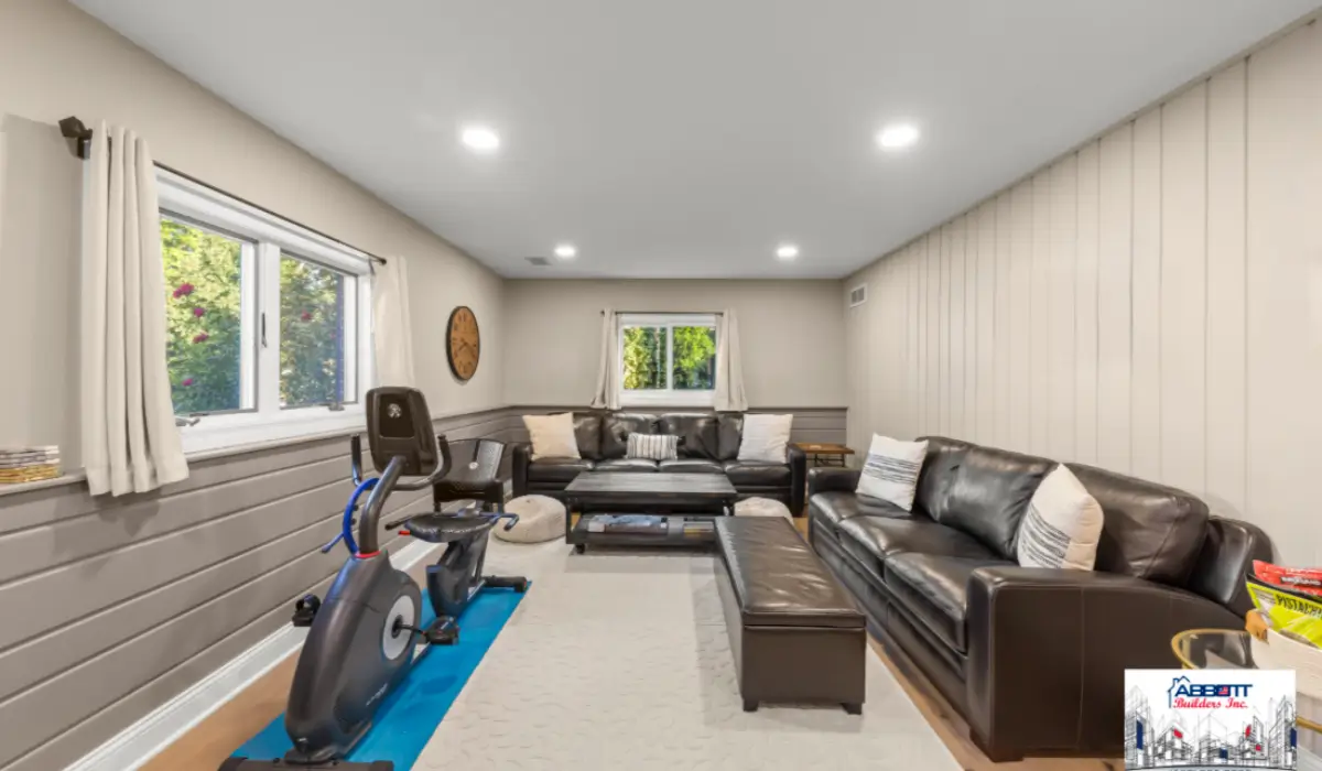 Modern finished basement with insulated walls, recessed lighting, and sealed windows to winterize your basement.