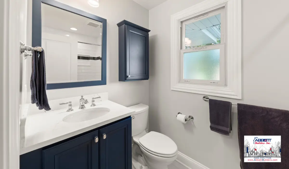 Small modern bathroom layout with navy vanity and storage, remodeled for a bathroom that feels cramped.