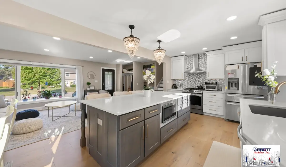 Kitchen remodel in 2026 showing quartz island, white cabinets, pendant lighting, and open layout improving home value.