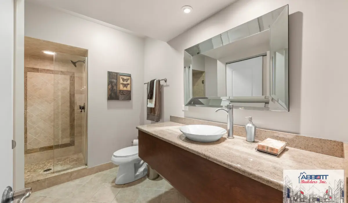 Bathroom Remodel Checklist featuring completed modern bathroom with custom vanity, glass shower, and durable tile finishes.