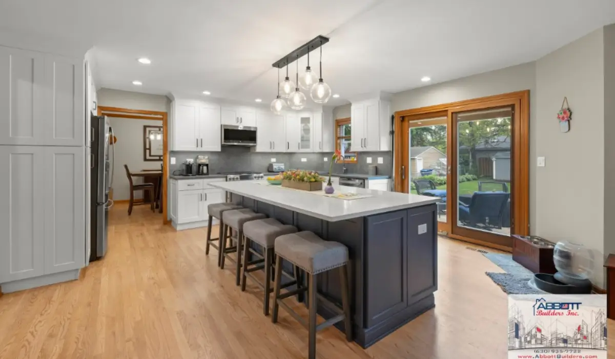 Naperville kitchen remodeling with island seating, pendant lighting, open walkways, and sliding doors connecting outdoor entertaining spaces.